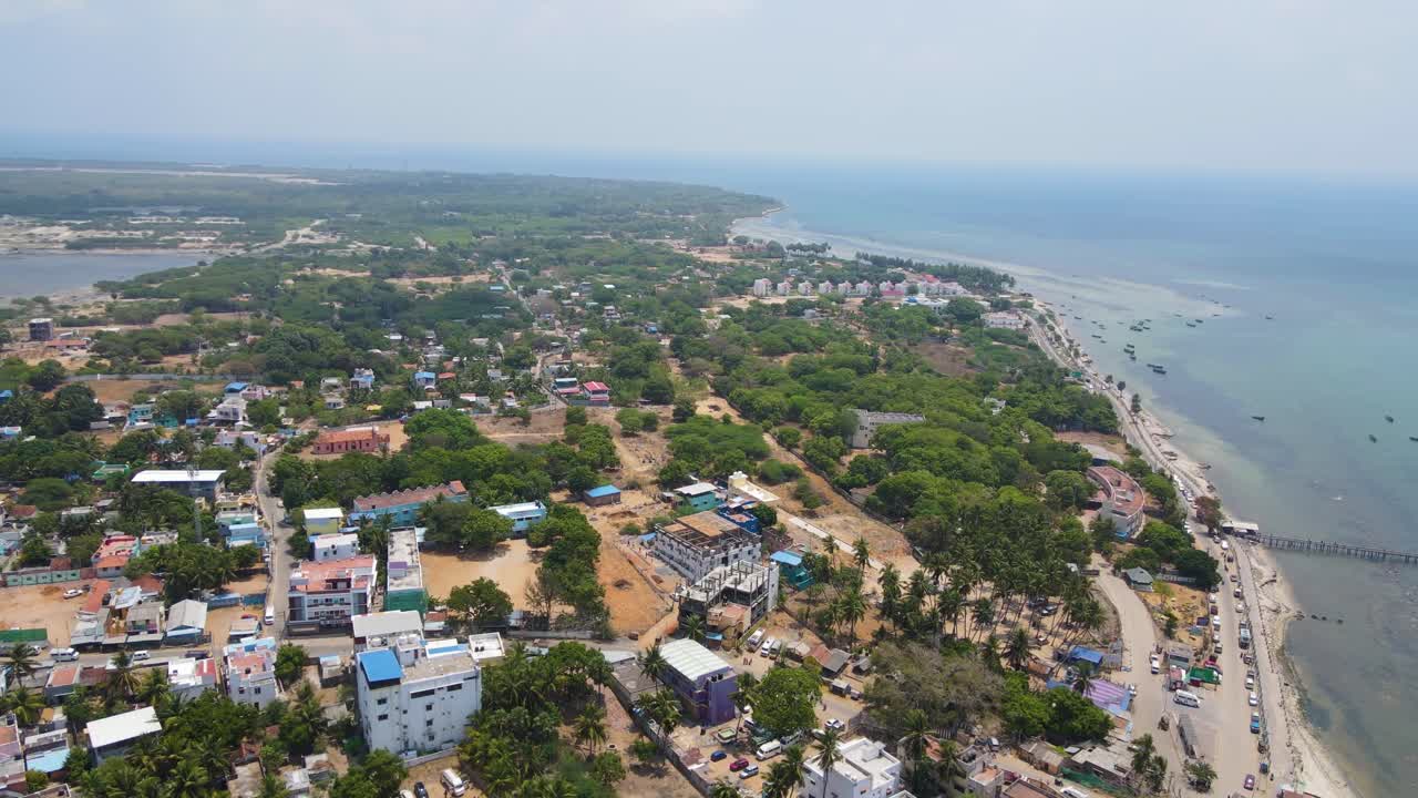 Immersive aerial drone shot of Rameshwaram city, with the temple standing prominently in the urban landscape.
