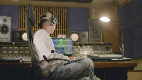 young caucasian man working at music recording studio