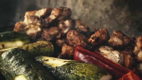 slow-motion close-up chicken wings and grilled vegetables,