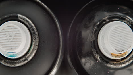 Overhead-Shot-Of-Used-Spray-Paint-Cans-With-Messy-Valve-Spray