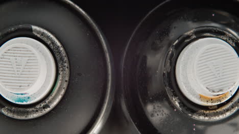 fotografía cenital de latas de pintura en spray usadas con spray de válvula desordenado