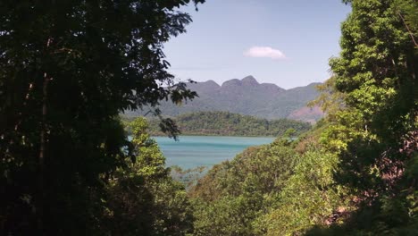 tropical viewpoint lush forest, ocean mountains, and islands, left to right tracking shot