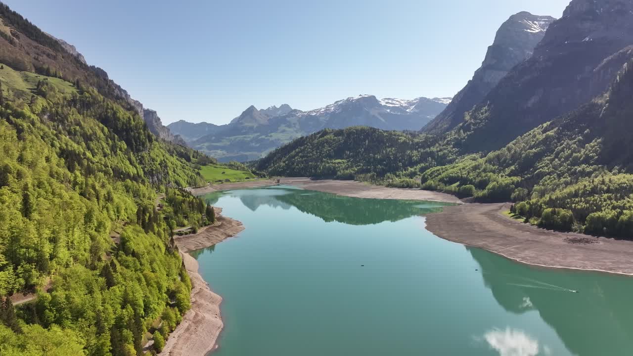 aerial lake Klöntalersee surrounded by alpine peaks and forests in Glarus Switzerland
