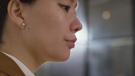 Close-Up-Of-Businesswoman-Sitting-At-Desk-Working-In-Office-