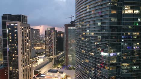 downtown miami skyline buildings at sunset illuminated with light, slow motion revealing shot