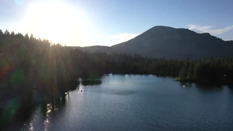 flying over lake tahoe surrounded by forest in california, usa at daytime - aerial drone shot
