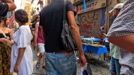 people walking and dining in a bustling street