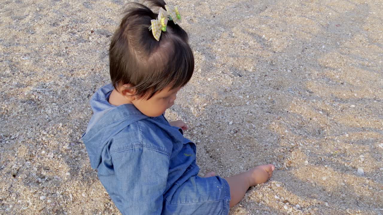 Child playing sandy beach outdoor environment fun activity joyful moment close-up perspective