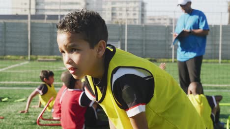 mixed race soccer kid exercising in a sunny day