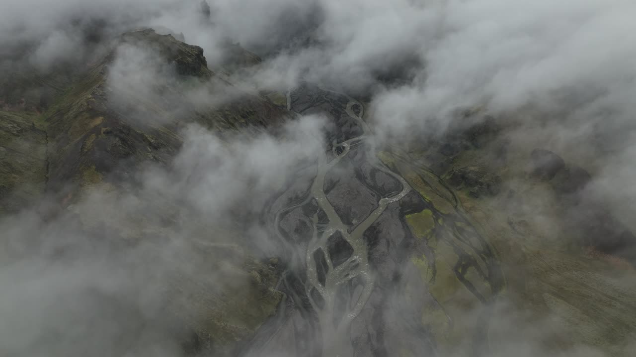 Aerial View of a Foggy Mountain Valley with a Winding River
