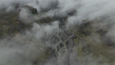 aerial view of a foggy mountain valley with a winding river