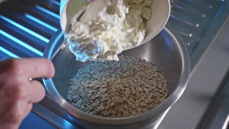 pouring oatmeal into a mixing bowl, adding low-fat cheese and eggs