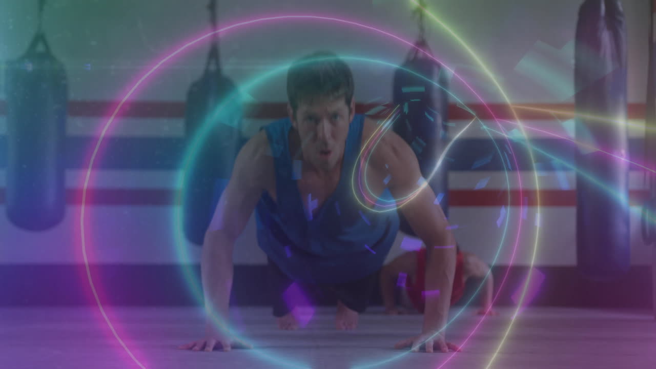 Doing push-ups in gym, man surrounded by colorful digital animation effects