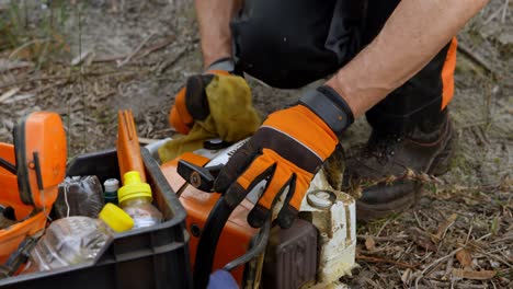 lumberjack cleaning the work tool with a cloth