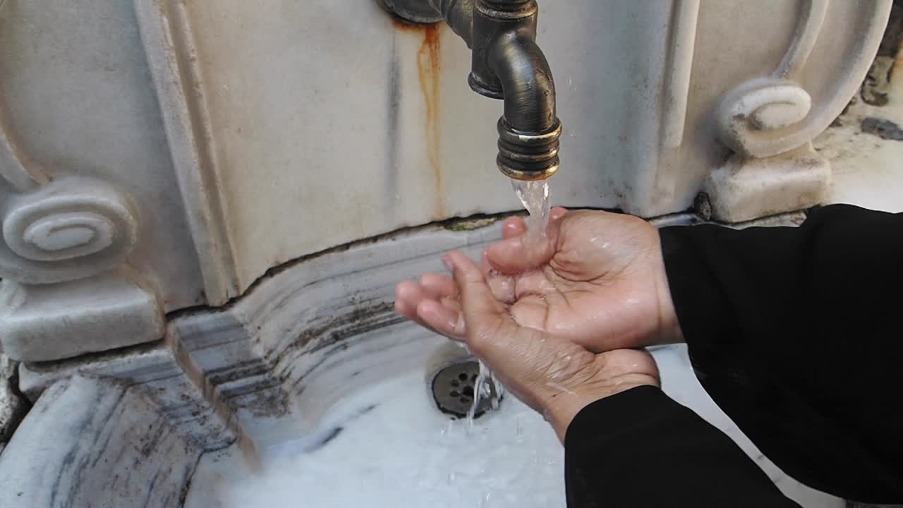 Washing Hands at a Traditional Ablution Fountain