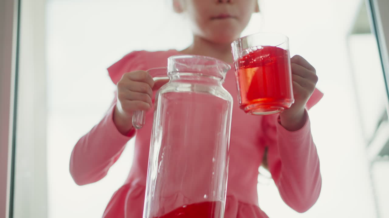 Young Girl Pouring Red Drink