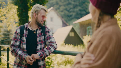 man wearing sunglasses talking to woman at vacation