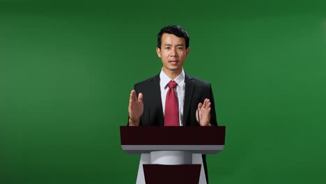 asian portrait of organization representative speaking at a press conference in government with mock up green screen, chroma key
