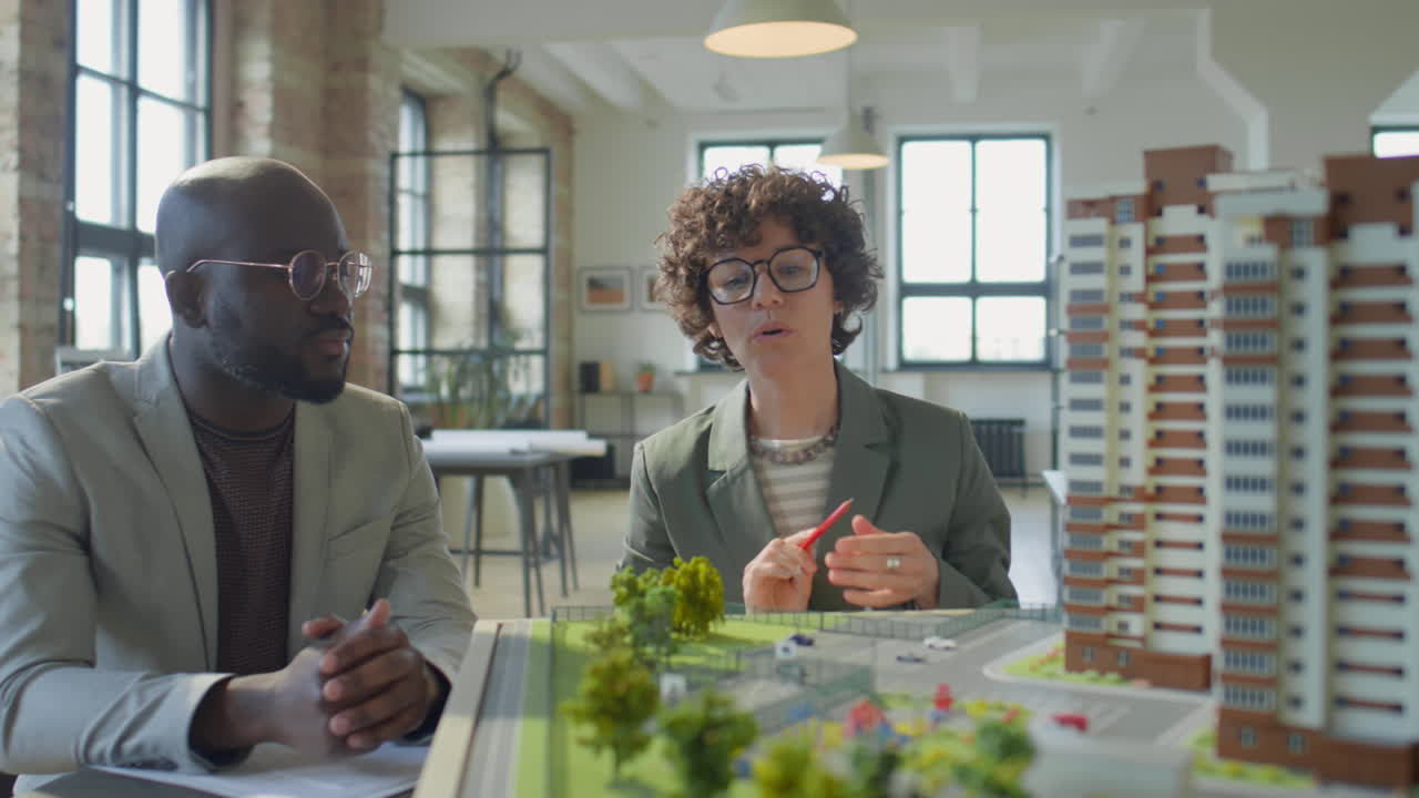 Architects or urban planners discussing a cityscape model