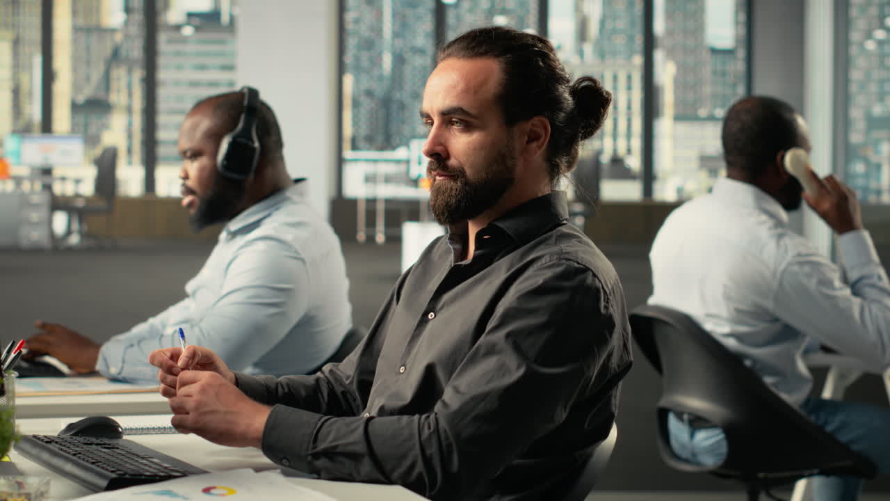 Vertical Video Male professional in a corporate workspace coordinates tasks and objectives