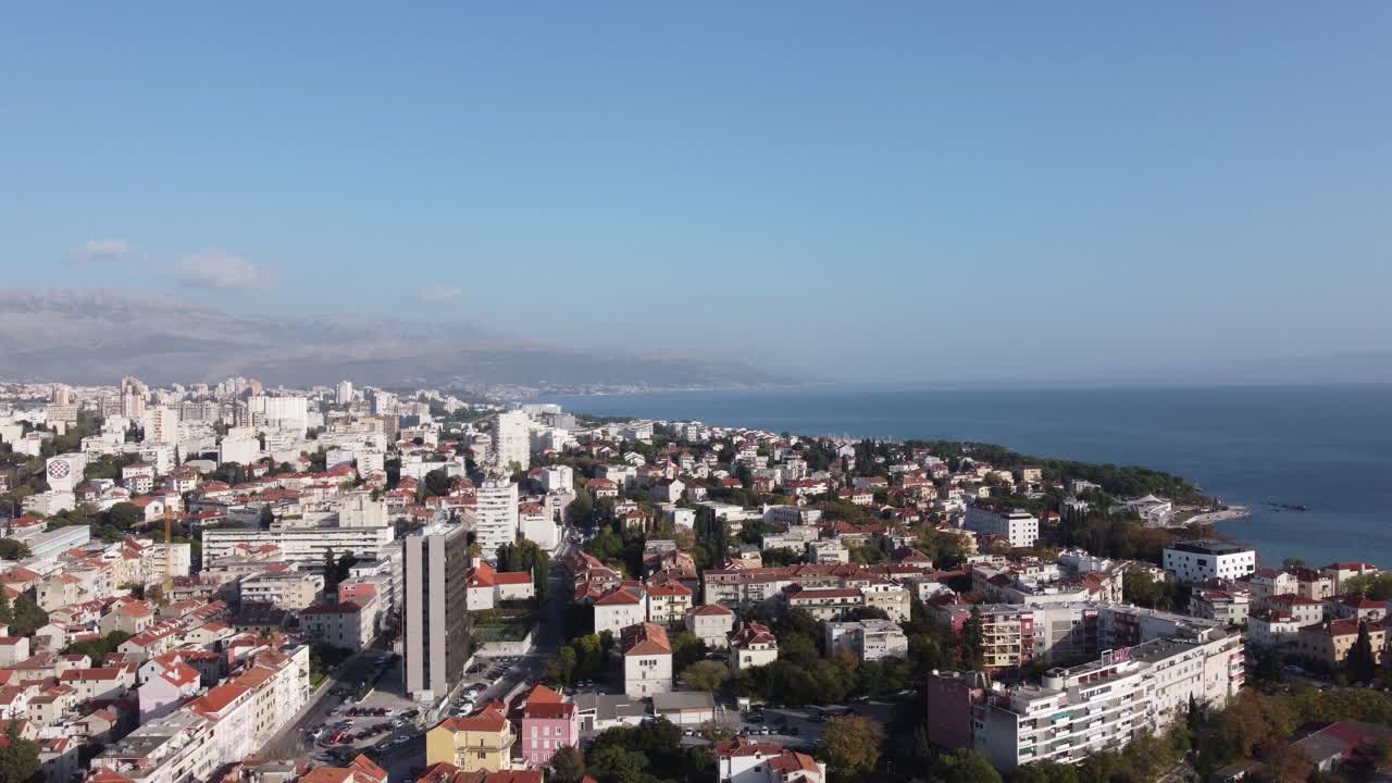 Aerial view of the city of Split, with its medieval and Roman buildings and the forest on the hill and the Dinaric Mountains on a sunny summer day with great tranquility, Split, Croatia.mp4