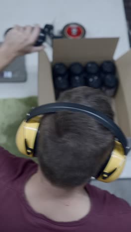 worker packaging products with ear protection