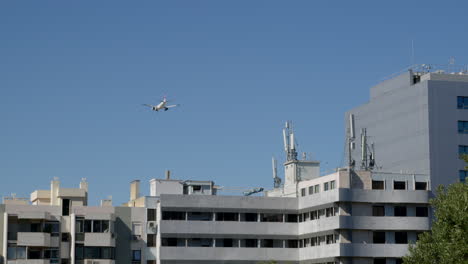 airplane flying over city buildings