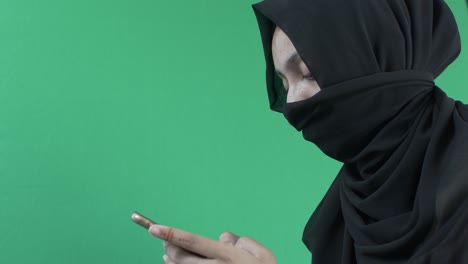 hijab muslim women texting on mobile phone