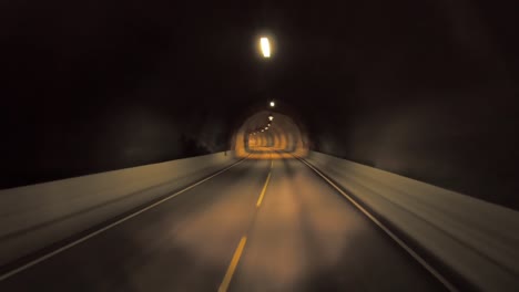 car rides through the tunnel point-of-view driving in norway. light at the end of the tunnel.