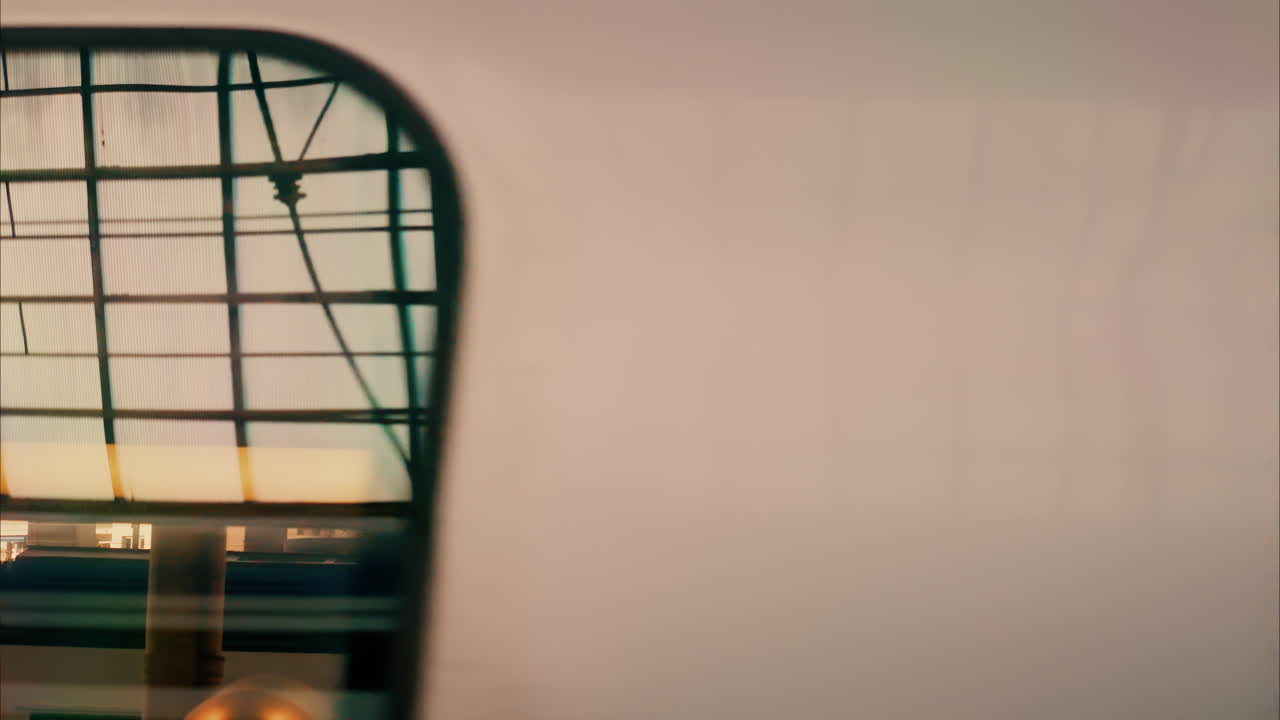 Close up view from a window of a train moving on the rails near a station in Nice, France