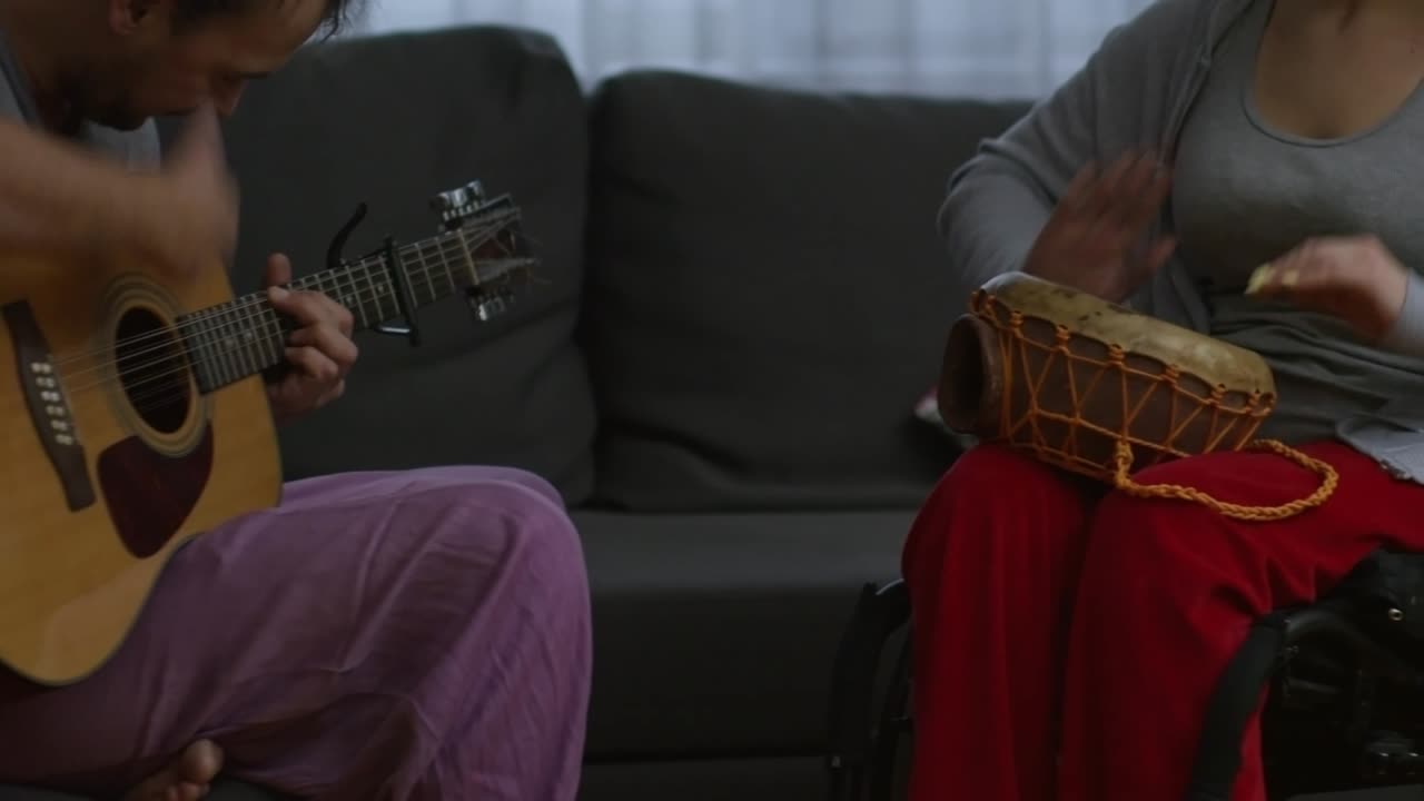 Unrecognizable Disabled Woman Playing Music with Partner