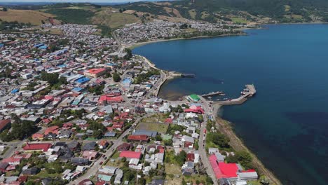 Aerial view of Ancud, a charming city on Chiloe Island, Chile, showcasing its colorful houses, streets, and pier against the backdrop of the Pacific Ocean