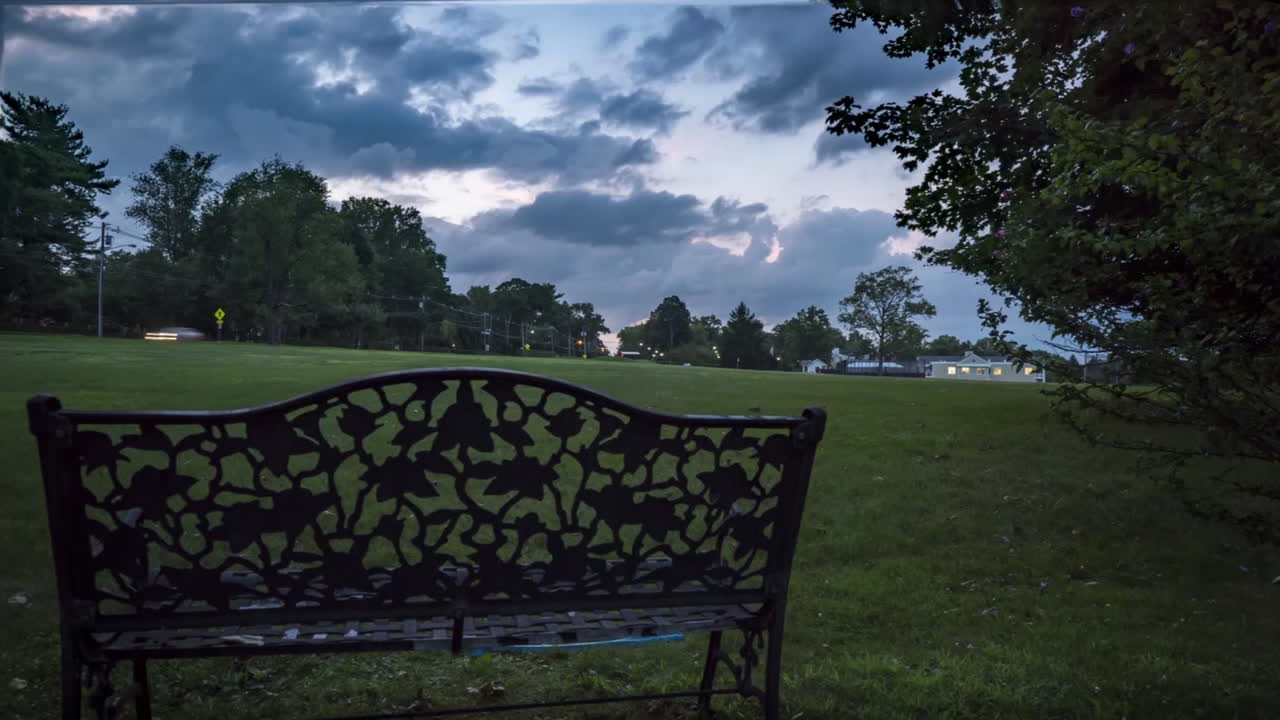 Panning timelapse of owner and dogs playing fetch, transitions to suburban sunset
