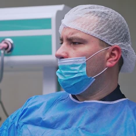checking all is fine. mature male surgeon controlling patient's health condition during surgical operation.