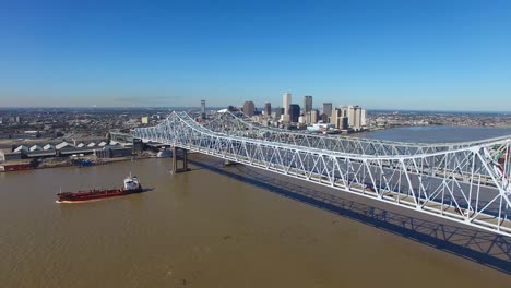 excellent aerial shot of the crescent city bridge over the mississippi river revealing the new orleans louisiana skyline