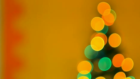 christmas tree with colorful bokeh and christmas lights..christmas and new year decoration. abstract bokeh holiday background. blinking garland. christmas lights twinkling.