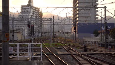 Slow-motion-view-of-beautiful-train-station-at-sunset-with-traffic-in-distance