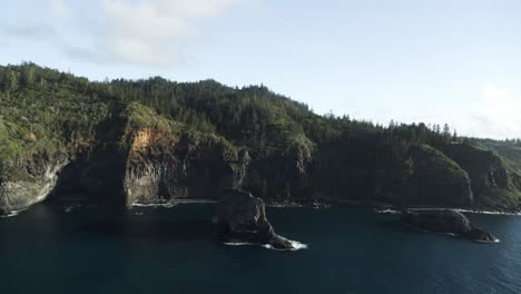 4k aerial - norfolk island, australia slow wide orbit around amazing rock formation dji inspire 2