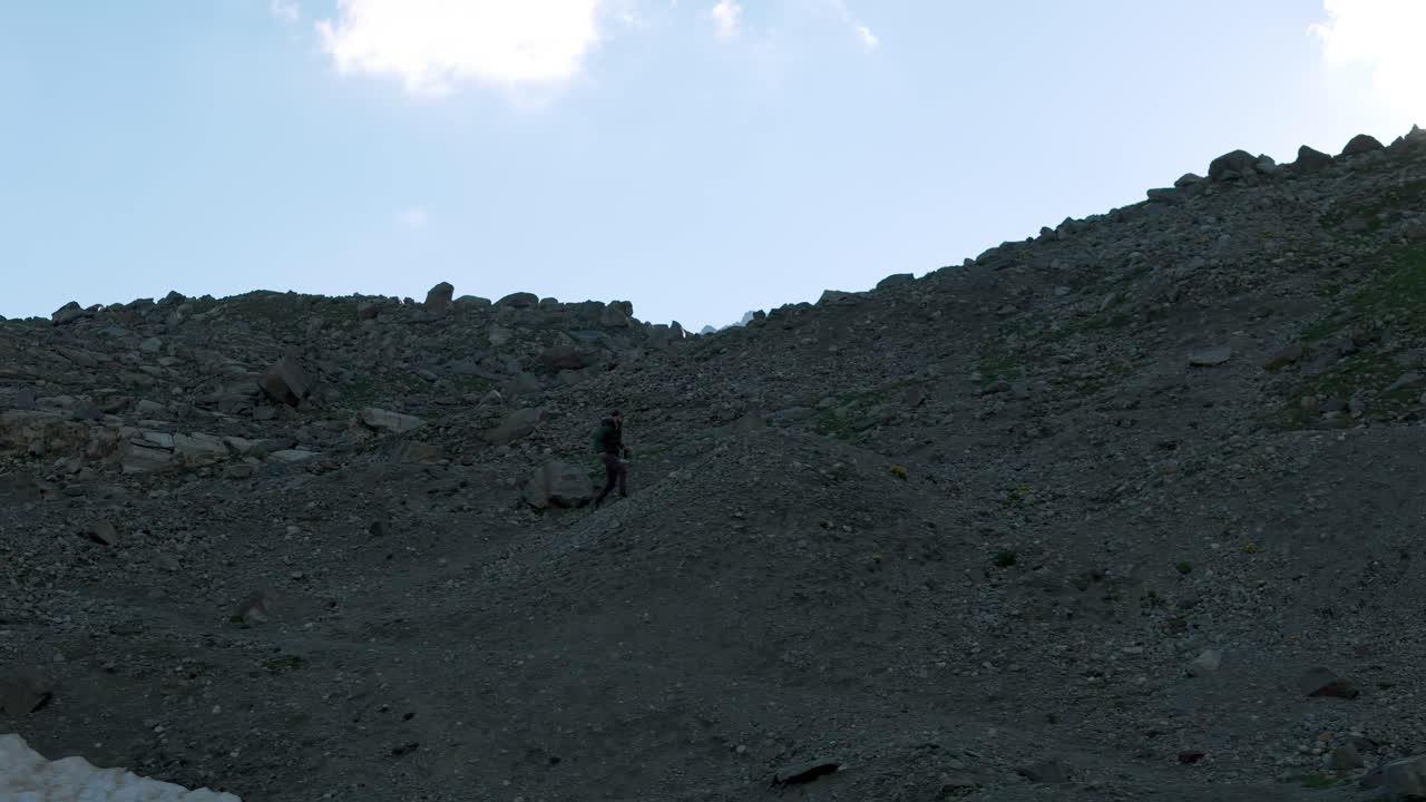 Valmalenco Alps, Lombardy, Italy - A Hiker Walking Along the Challenging and Rugged Hiking Trails - Pan Right Shot