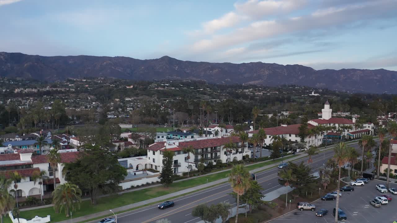 Low aerial dolly shot along Cabrillo Blvd. during sunset in Santa Barbara, California. 4K