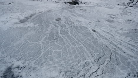 pov footage of a winter boat journey through norway's geirangerfjord, capturing stunning views of ice in the water from the surrounding snowy mountains