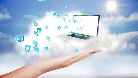 Hand-presenting-laptop-and-app-icons-against-clouds