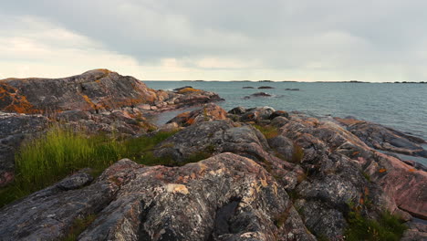 Beautiful-nature-of-the-Island-rocks-with-grass-and-mosses-on-the-ocean-waves-summertime-in-Sweden