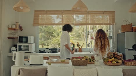 couple cooking together in a tropical kitchen