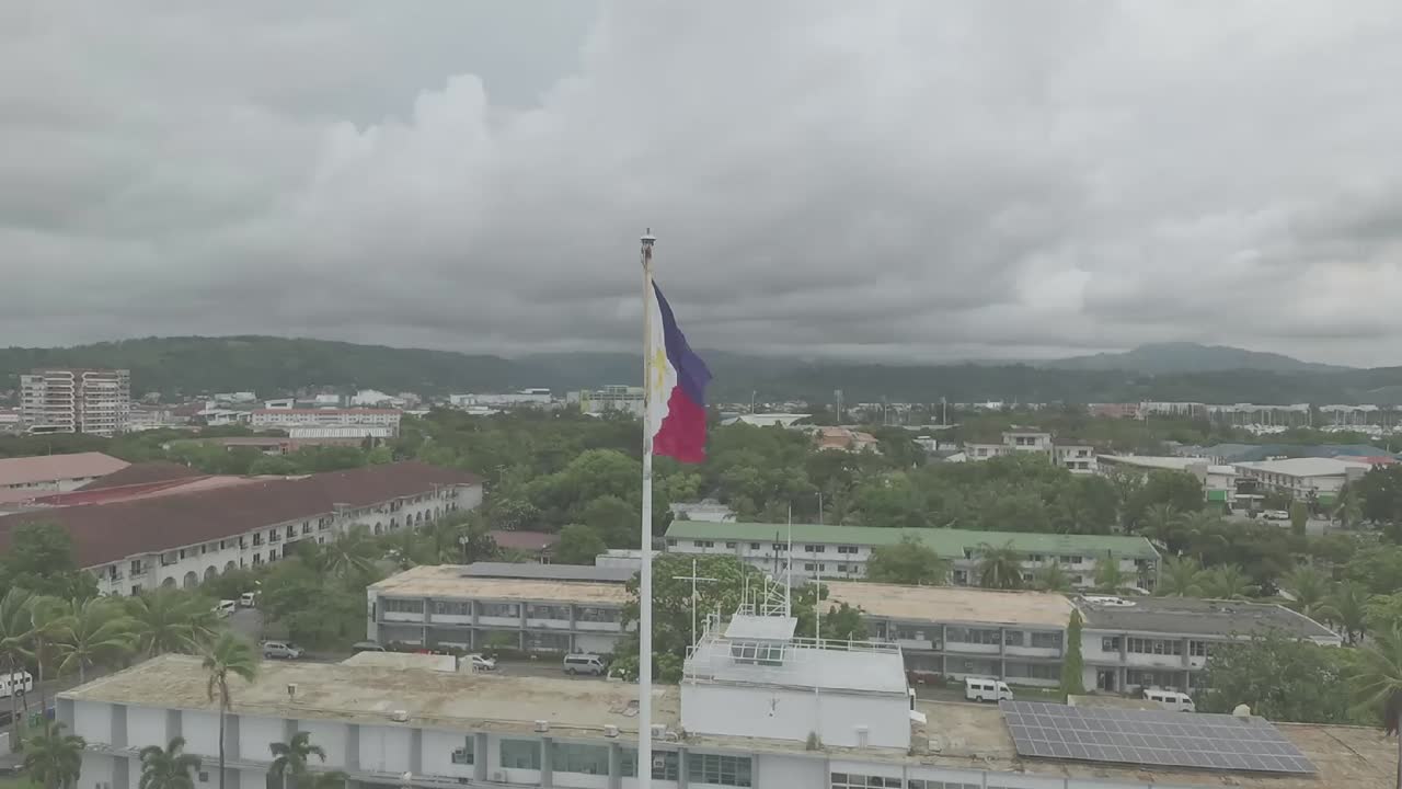The Philippine flag features horizontal stripes with vibrant colors, a central emblem or symbol that represents the nation or entity, and a simple yet impactful design that conveys unity and identity.