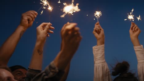 Friends-dancing-together-at-the-rooftop-with-sparkles.