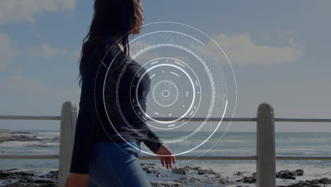 animation of scope scanning over woman with artificial limb walking by seaside