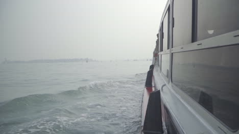 slow motion of water and water taxi window reflection in venetian lagoon, italy