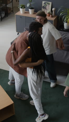 friends hugging and exchanging gifts at a casual social gathering