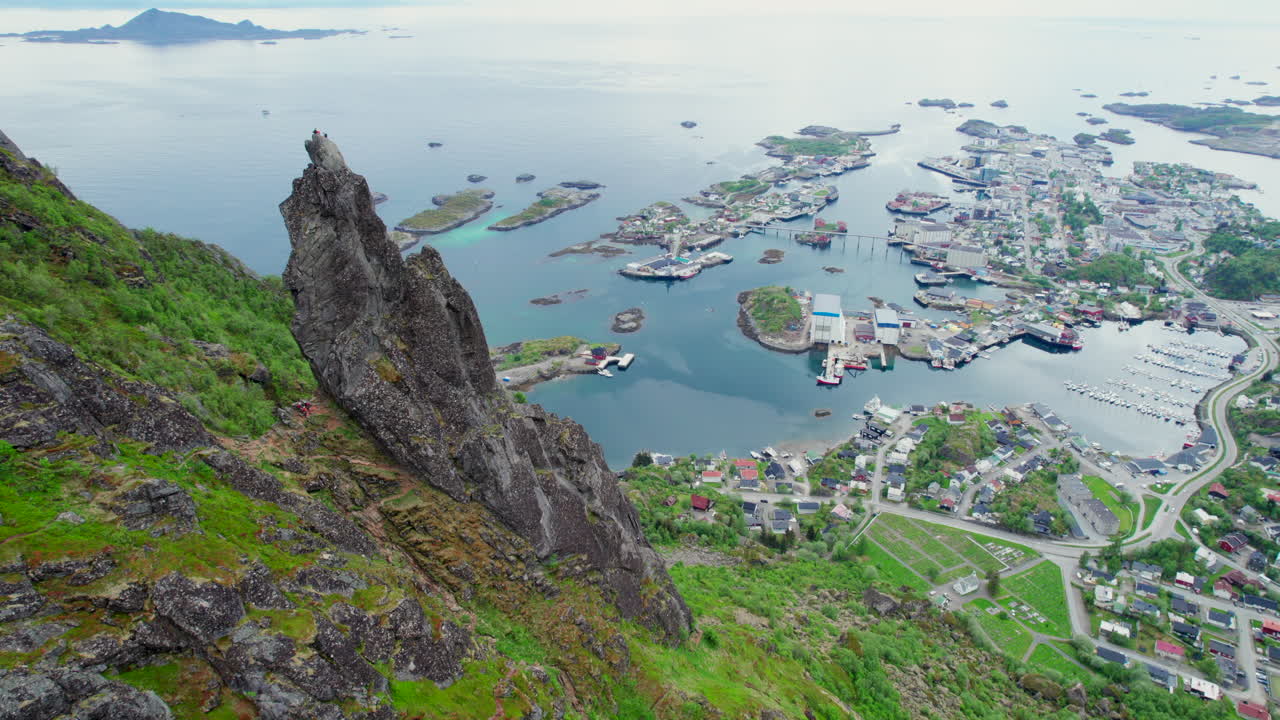 Svolvargeita pinnacle dominates the landscape, offering breathtaking views of Svolvar town, nestled amidst the serene waters and islands of the Lofoten archipelago